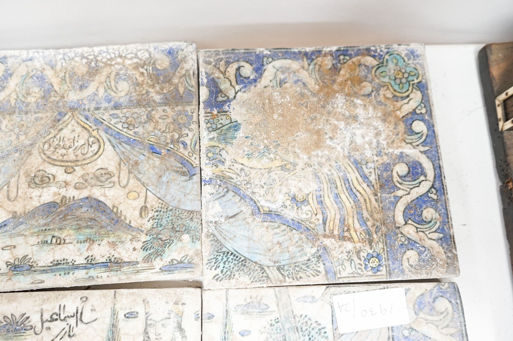 A Persian fritware tile panel, late 19th/early 20th century, incomplete, 55cm wide and another tile fragment